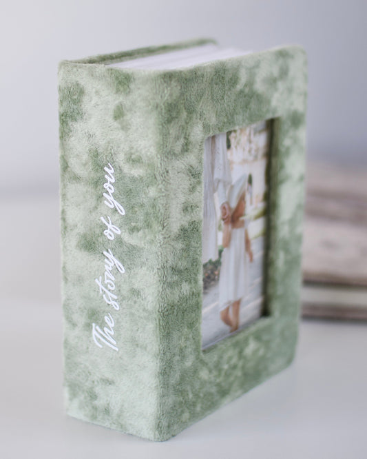 Green photo album with 'The Story of You' text on a white background